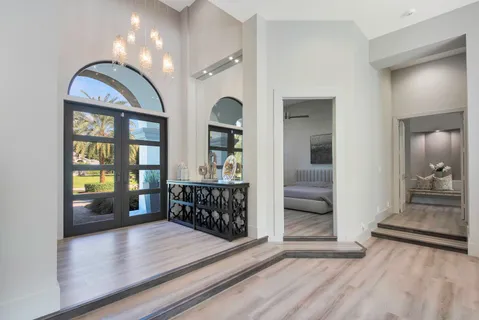 a living room with furniture a fireplace and a chandelier
