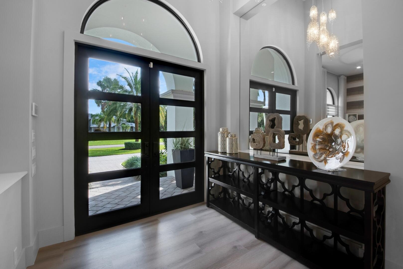 15271 Tall Oak Avenue Delray Beach, FL 33446 - Photo 21 of 60 a room with lots of wooden furniture and a floor to ceiling window