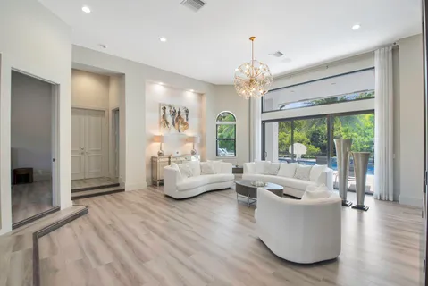 a view of a dining room with furniture and chandelier
