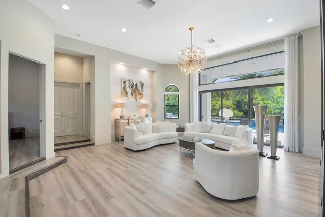 a view of a dining room with furniture and chandelier