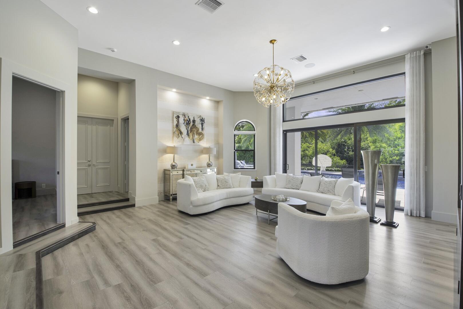 15271 Tall Oak Avenue Delray Beach, FL 33446 - Photo 25 of 60 a living room with furniture and a chandelier