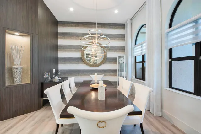 a large kitchen with granite countertop a large counter top stainless steel appliances a sink and living room view