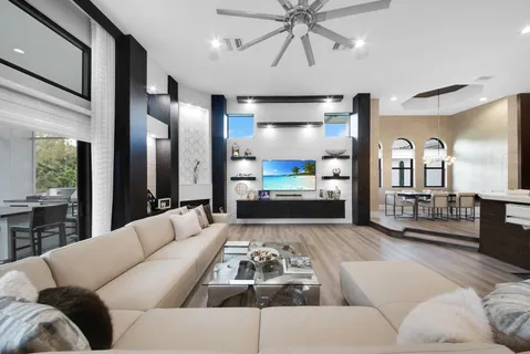 a living room with furniture and wooden floor