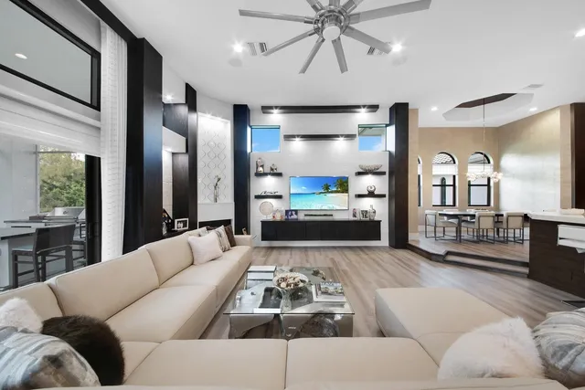 a living room with furniture and wooden floor