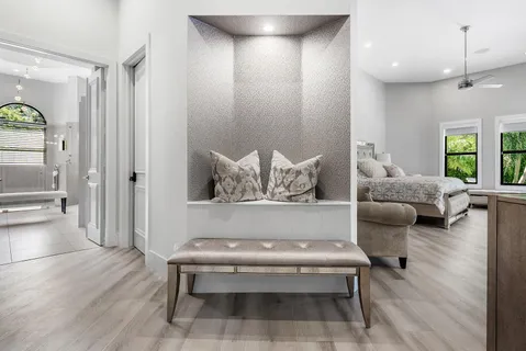 a bedroom with furniture and large windows