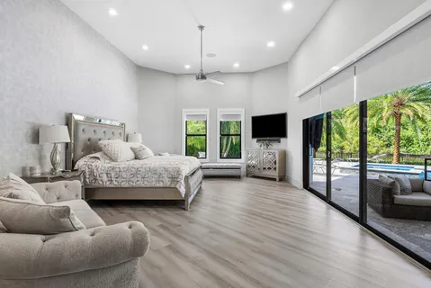 a bedroom with a bed and a large mirror