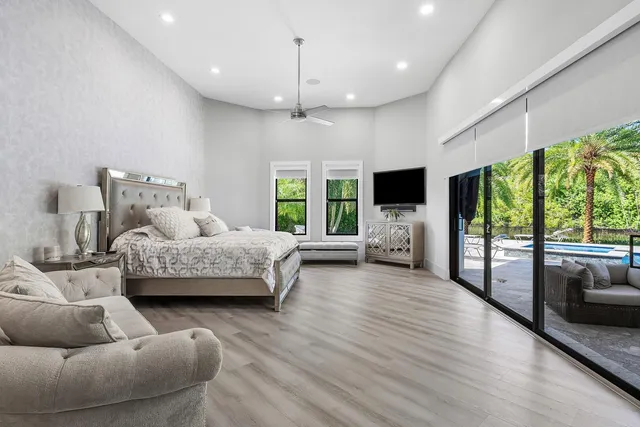 a bedroom with a bed and a large mirror