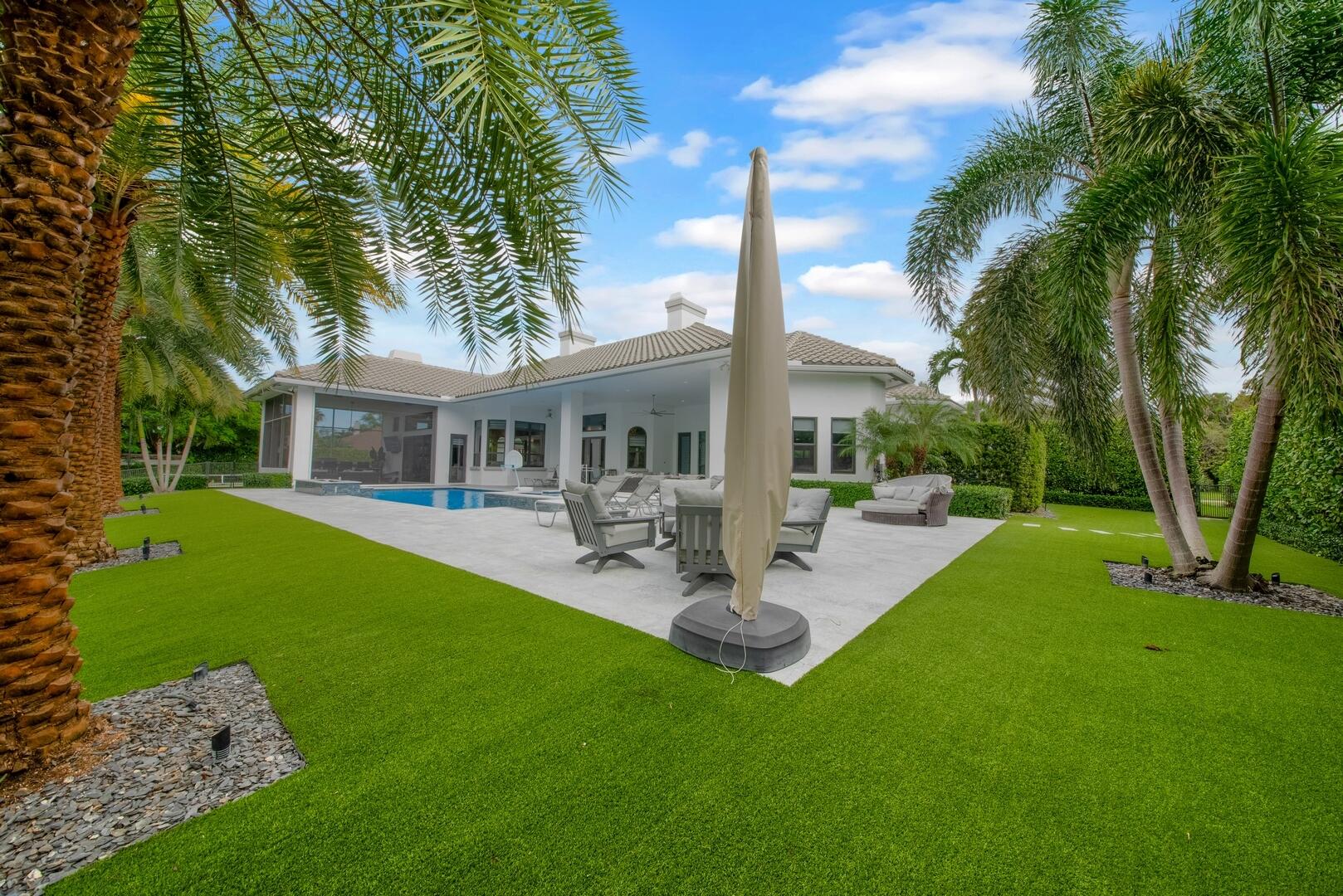 15271 Tall Oak Avenue Delray Beach, FL 33446 - Photo 51 of 60 a view of a house with backyard sitting area and garden