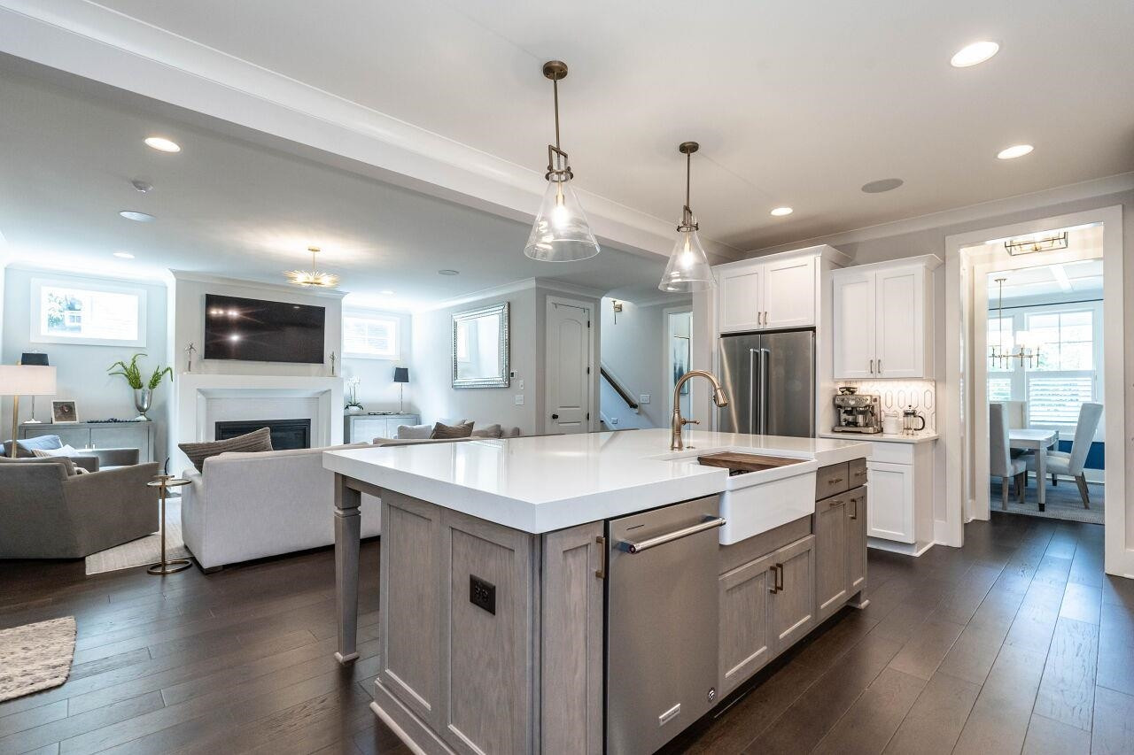 731 New Road Raleigh, NC 27608 - Photo 13 of 28 a large white kitchen with lots of counter space a sink appliances and living room view