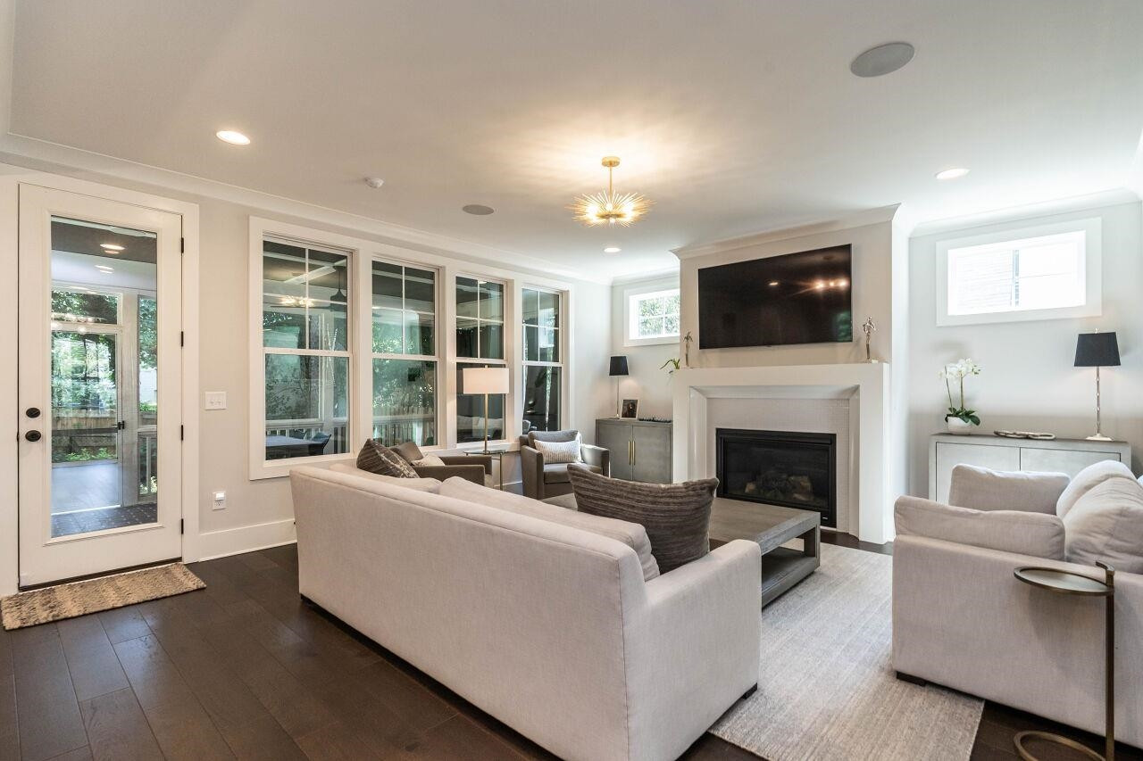 731 New Road Raleigh, NC 27608 - Photo 6 of 28 a living room with furniture a fireplace and a flat screen tv
