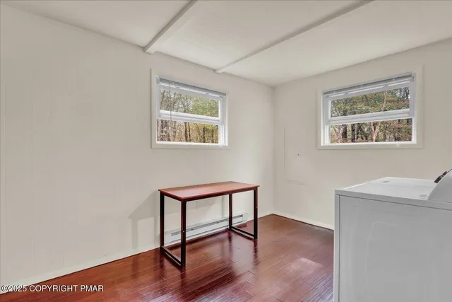 a view of a livingroom with furniture and wooden floor