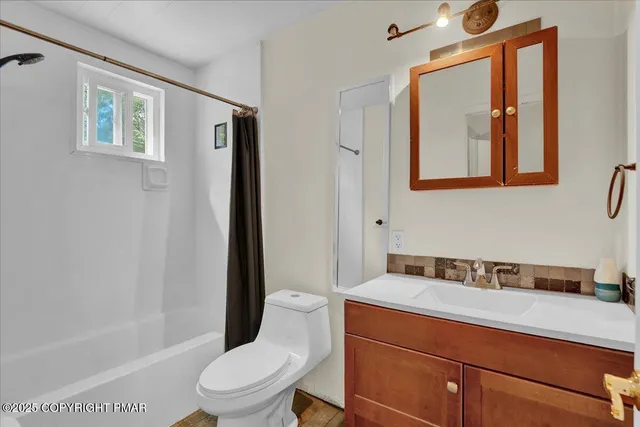 a bathroom with a toilet a sink and bathtub