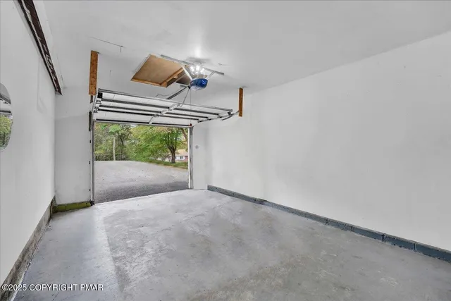 a view of a livingroom with wooden floor and stairs