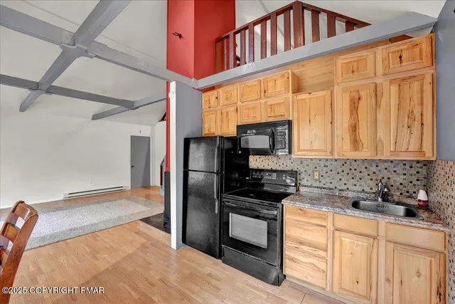 a kitchen with stainless steel appliances granite countertop a refrigerator a stove and a sink