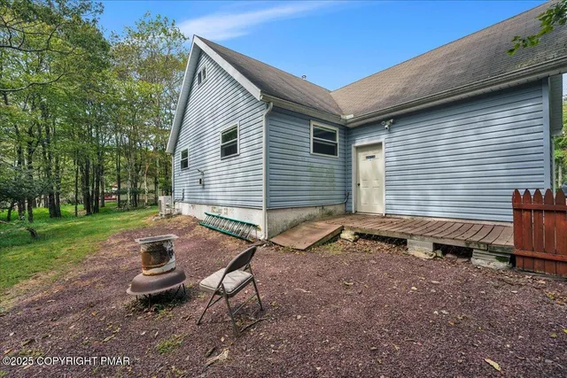 a backyard of a house with outdoor seating