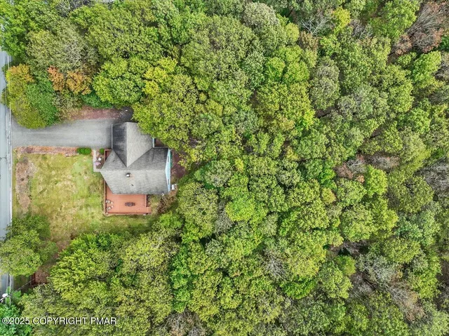 an aerial view of a house with a yard and garden