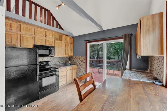 a kitchen with granite countertop a stove a sink and a refrigerator