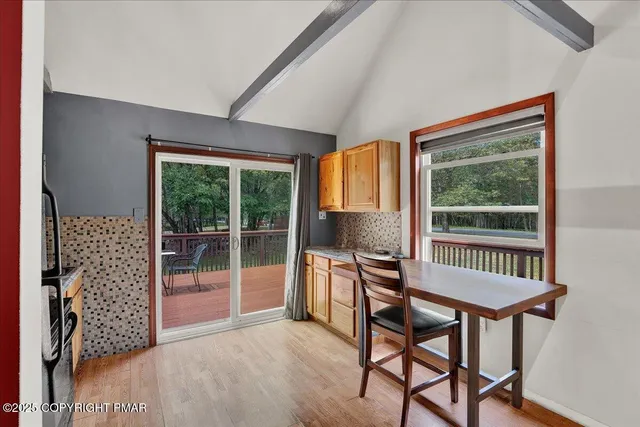 a view of a room with furniture wooden floor and windows