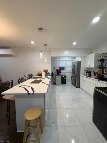 a bed room with a bed a couch and a chandelier