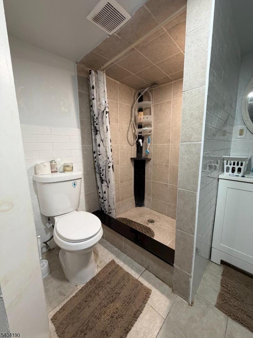 746 Murray Street, Unit 1 Elizabeth, NJ 07202 - Photo 19 of 28 a bathroom with a toilet and a shower