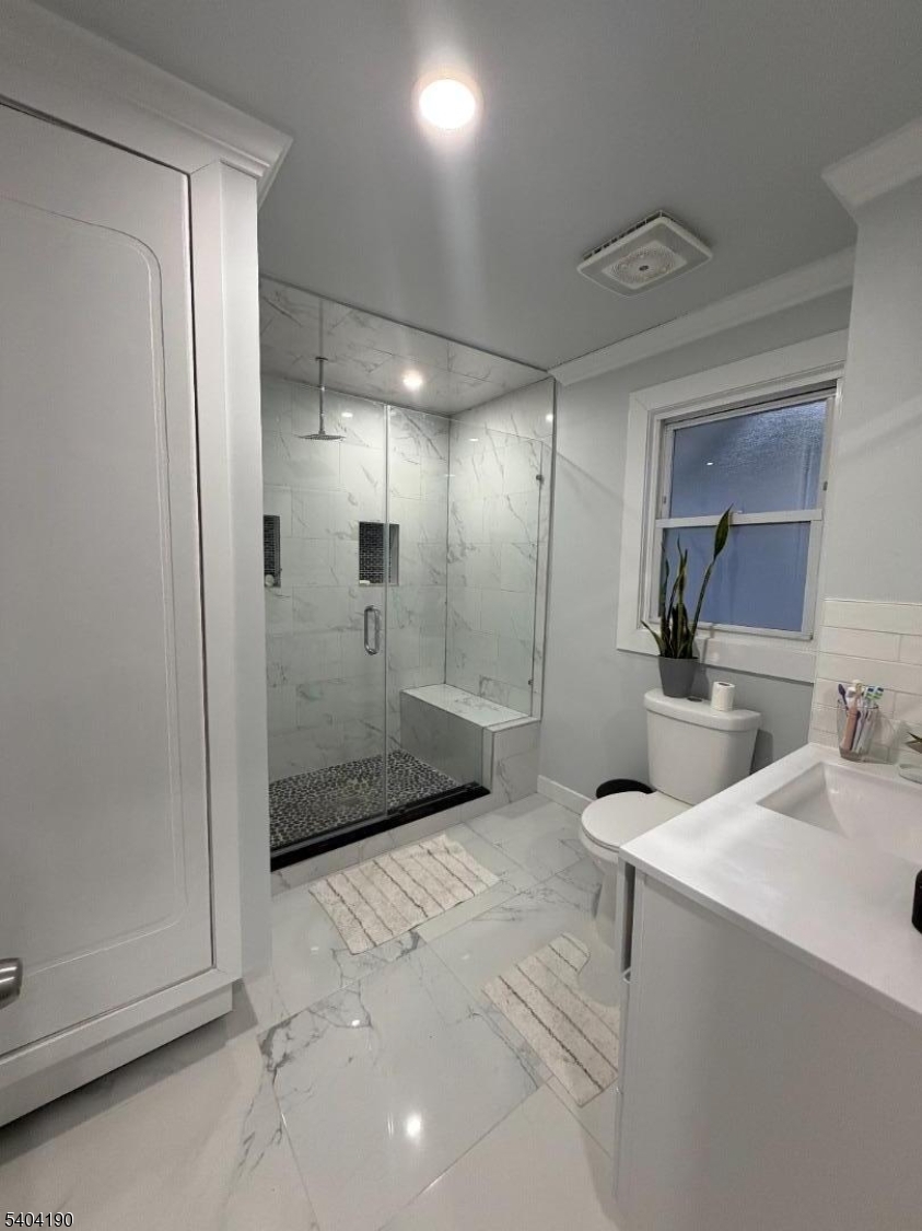 746 Murray Street, Unit 1 Elizabeth, NJ 07202 - Photo 25 of 28 a bathroom with a sink a toilet and mirror