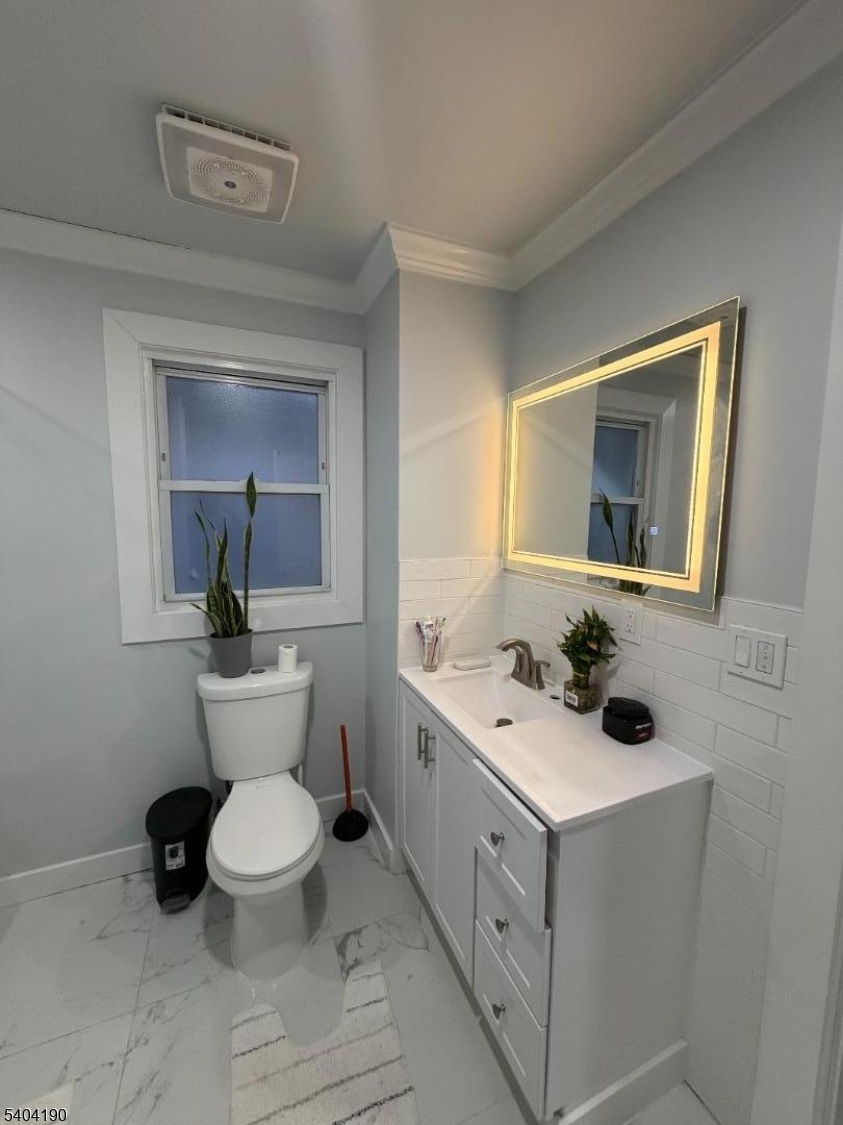 746 Murray Street, Unit 1 Elizabeth, NJ 07202 - Photo 27 of 28 a bathroom with a toilet sink and mirror
