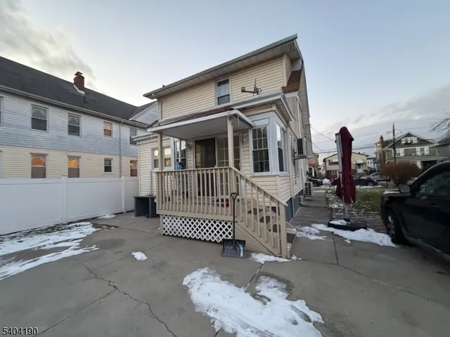 a view of a house with wooden fence