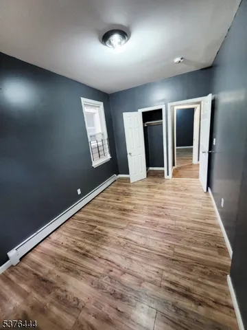 an empty room with closet and mirror