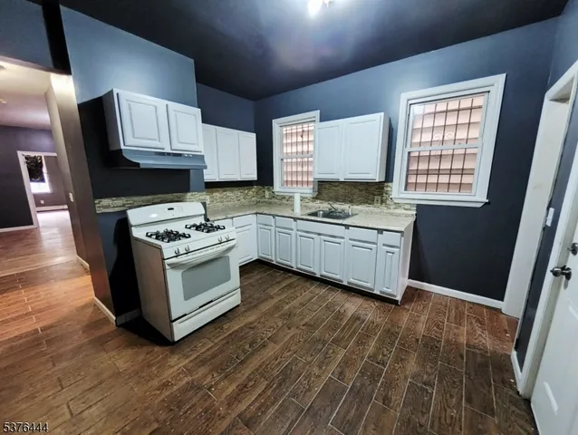 a kitchen with a sink appliances and cabinets