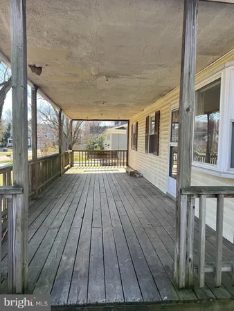 a view of a house with a large window and wooden floor