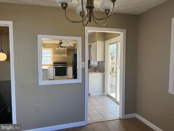 a large white kitchen with a sink and cabinets