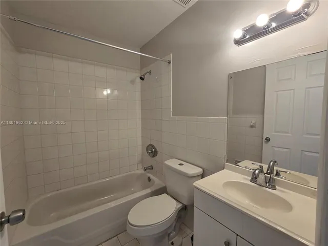 a bathroom with a sink toilet tub and shower