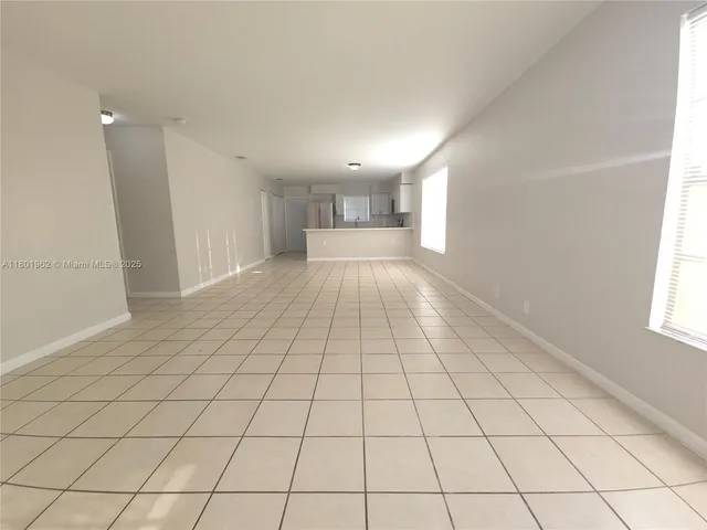 a view of a hallway and closet with a window