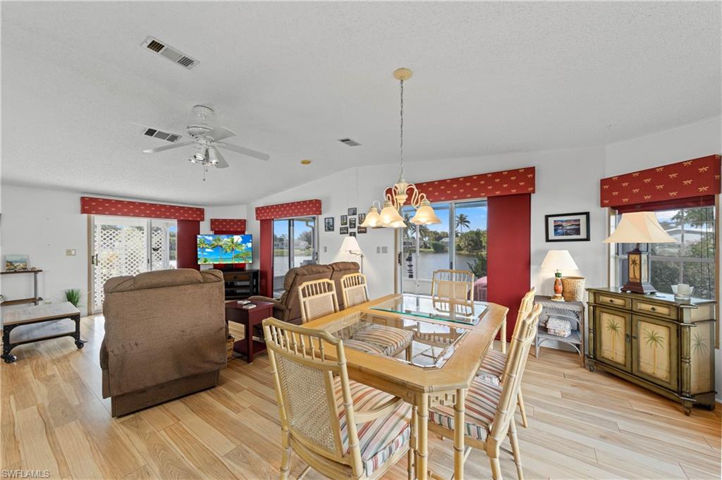 265 Riverwood Road Naples, FL 34114 - Photo 1 of 31 a view of a dining room with furniture and wooden floor