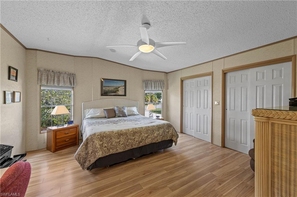 265 Riverwood Road Naples, FL 34114 - Photo 11 of 31 a bedroom with a bed and a chandelier