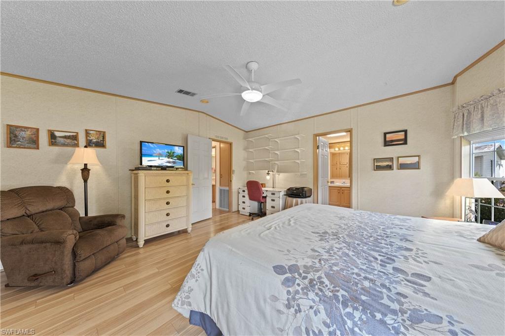 265 Riverwood Road Naples, FL 34114 - Photo 12 of 31 a view of a bedroom with furniture and window