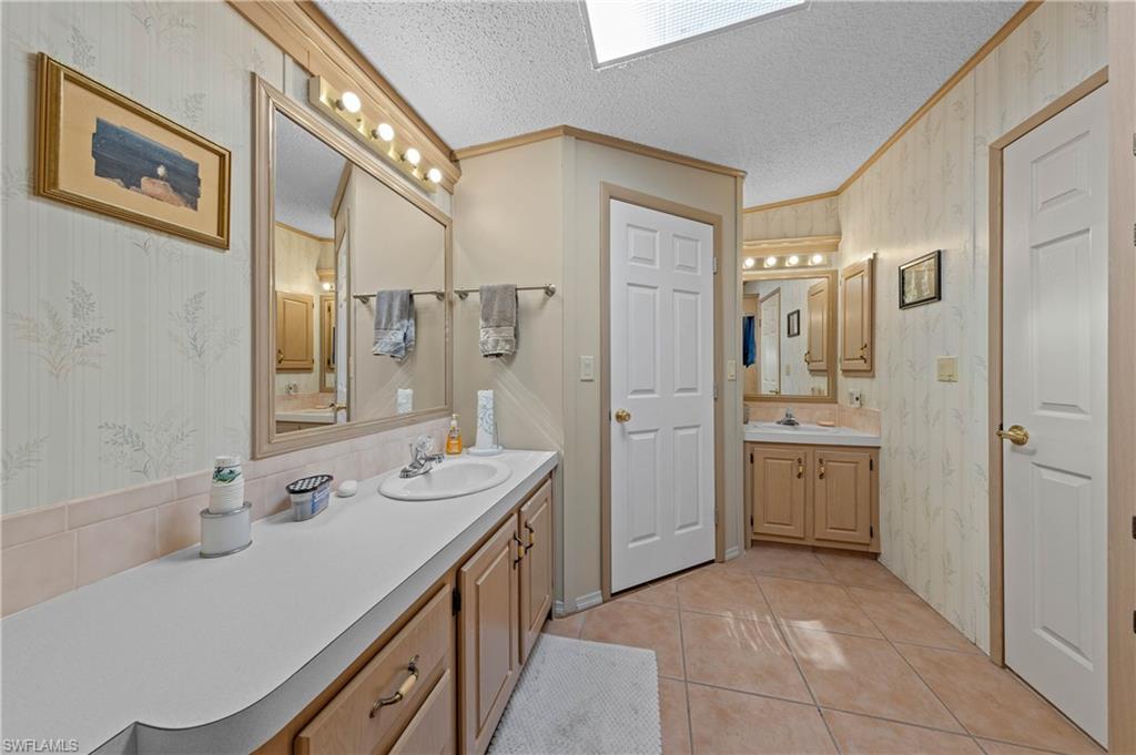 265 Riverwood Road Naples, FL 34114 - Photo 14 of 31 a spacious bathroom with a double vanity sink mirror and double