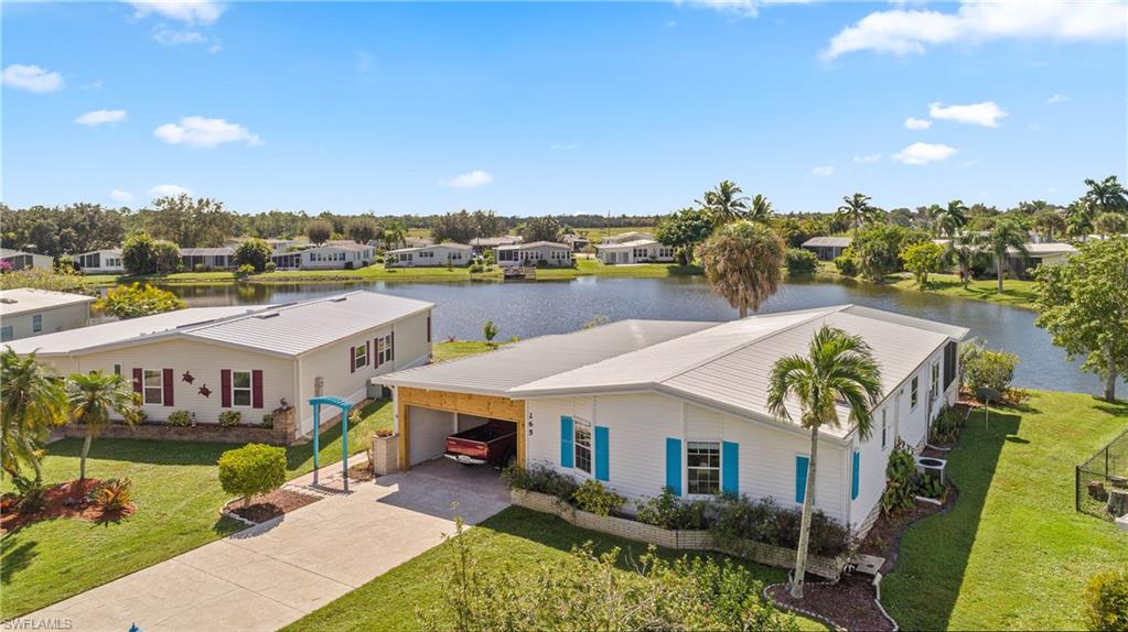265 Riverwood Road Naples, FL 34114 - Photo 23 of 31 a aerial view of a house with swimming pool outdoor seating