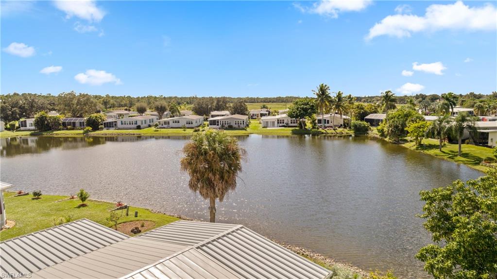 265 Riverwood Road Naples, FL 34114 - Photo 26 of 31 a view of a lake with a house in the background