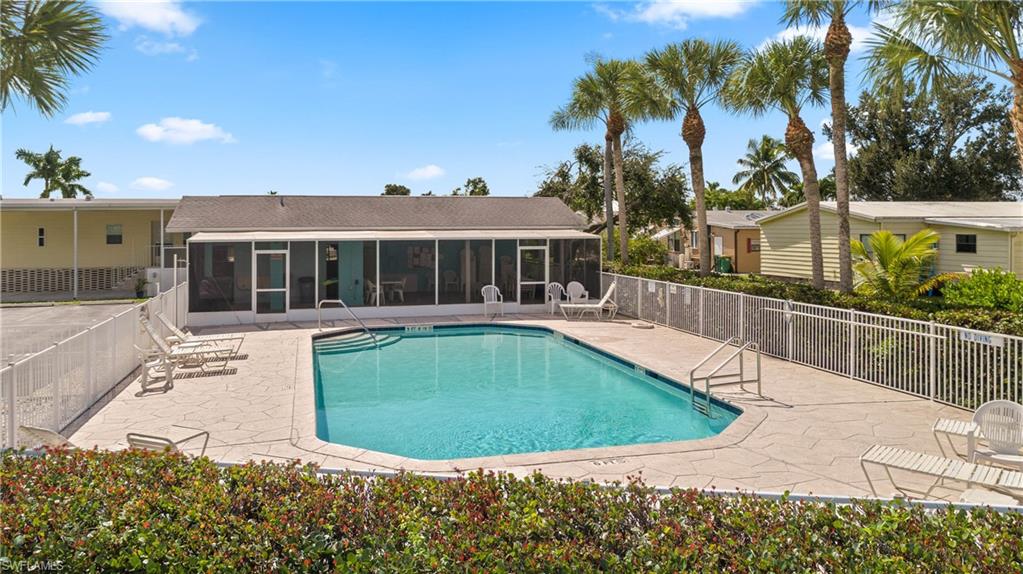 265 Riverwood Road Naples, FL 34114 - Photo 28 of 31 a view of a house with a swimming pool