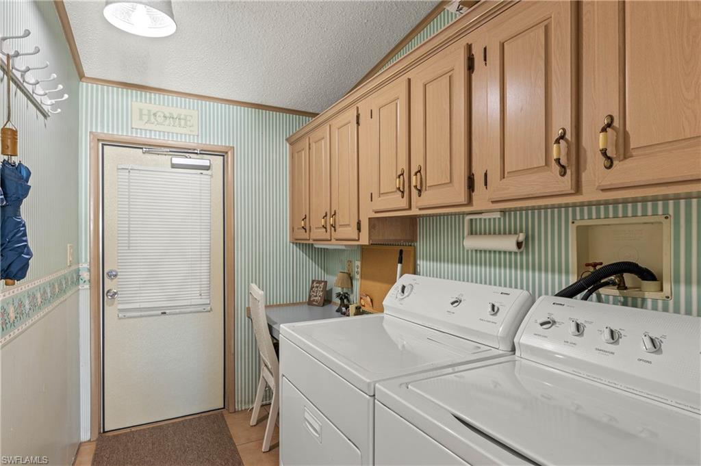 265 Riverwood Road Naples, FL 34114 - Photo 10 of 31 a kitchen with a sink a refrigerator and cabinets