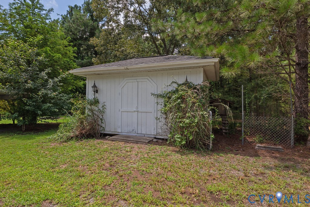20100 Frog Level Road Ruther Glen, VA 22546 - Photo 22 of 28 White exterior shed with double doors, featuring a