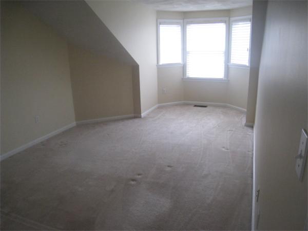 663 Lowell Street, Unit 37 Lexington, MA 02420 - Photo 9 of 13 an empty room that has a window