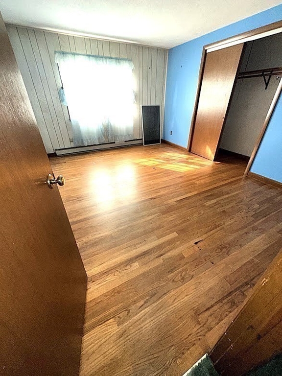 208 Roy Street Springfield, MA 01104 - Photo 11 of 15 a view of an empty room with wooden floor and a window