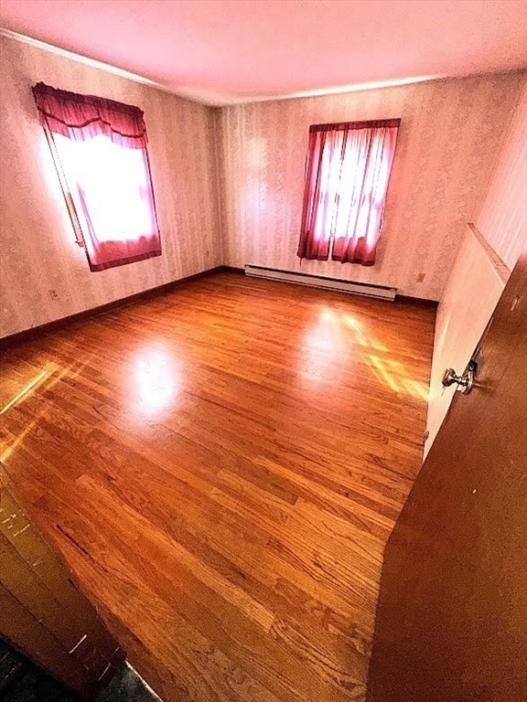 208 Roy Street Springfield, MA 01104 - Photo 12 of 15 a view of empty room with wooden floor and fan