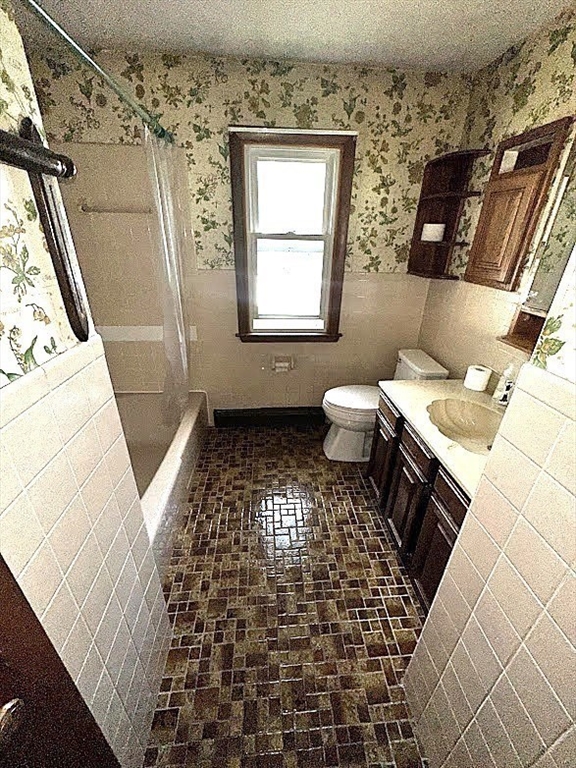 208 Roy Street Springfield, MA 01104 - Photo 9 of 15 a bathroom with a toilet a sink and a window