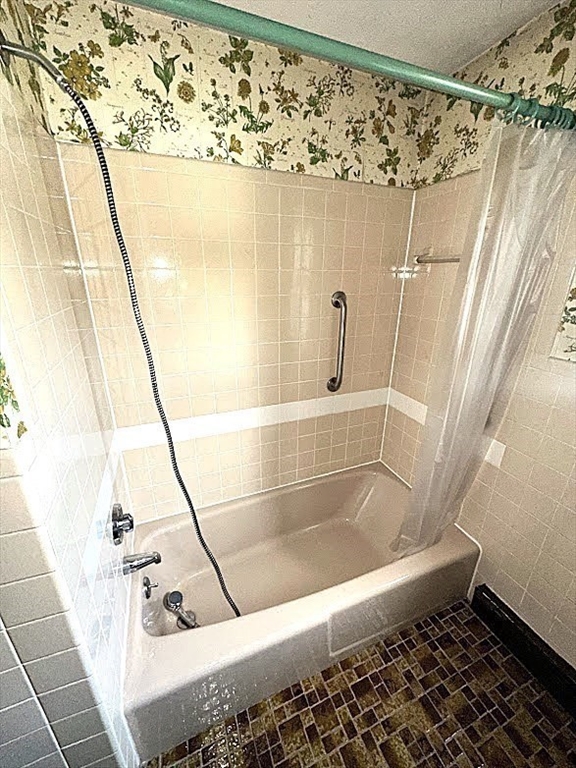 208 Roy Street Springfield, MA 01104 - Photo 10 of 15 a bath tub sitting next to a white sink and vanity