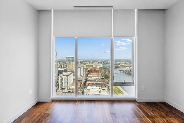 an view of room with window and wooden floor