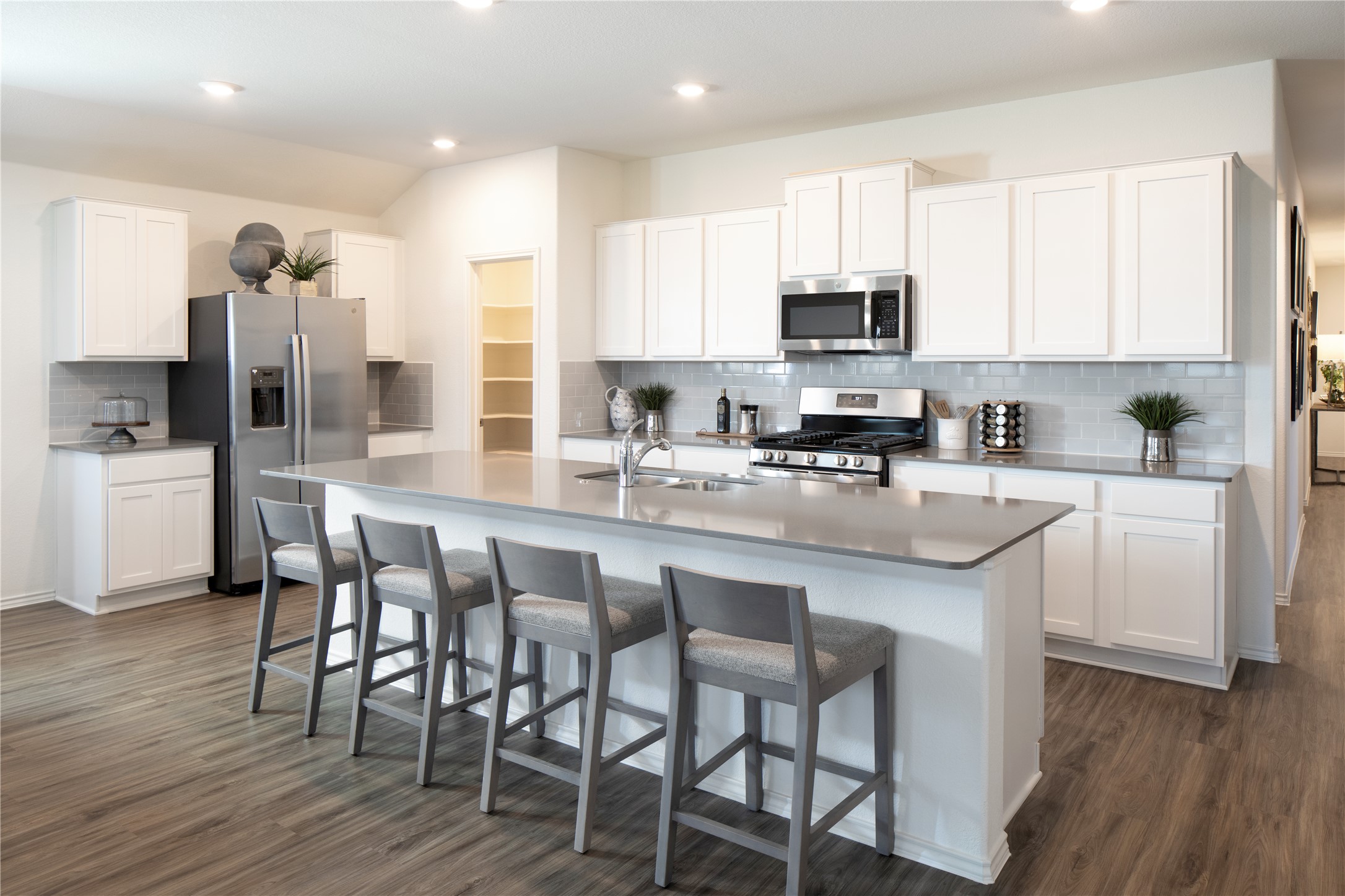 129 Arbordale Street Georgetown, TX 78628 - Photo 6 of 18 a kitchen with stainless steel appliances granite countertop a table chairs microwave and sink