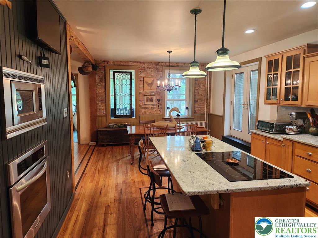 861 Municipal Road Walnutport, PA 18088 - Photo 17 of 94 a kitchen with stainless steel appliances granite countertop a stove a refrigerator a oven a sink with island and chairs